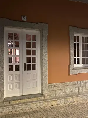 a white door on the side of a building at ACASADACONCHA in Moeche