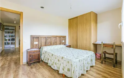 a bedroom with a bed and a table and a desk at Beautiful Home In Diomondi With Wifi in Diomondi