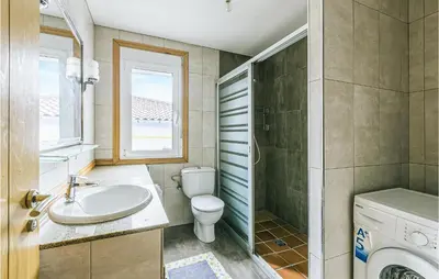 a bathroom with a sink and a toilet and a window at Beautiful Home In Diomondi With Wifi in Diomondi