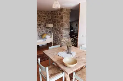 a dining room with a wooden table and chairs at El Escondite Inglés in Pantón