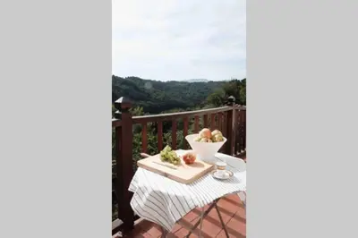 a table with a bowl of fruit on a balcony at El Escondite Inglés in Pantón