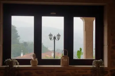 a window with a view of a street light at Casa de piedra, A Lameira in A Coruña