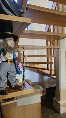 a doll wearing a top hat sitting on a shelf at Casa de piedra, A Lameira in A Coruña