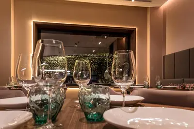 a restaurant with tables and chairs and a large window at Mercure Lugo Centro in Lugo