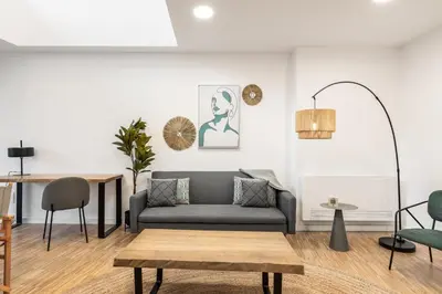 a living room with a couch and a table at I Loft Santiago by Upper Luxury Housing in Santiago de Compostela