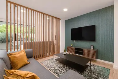 a living room with a couch and a flat screen tv at I Loft Santiago by Upper Luxury Housing in Santiago de Compostela