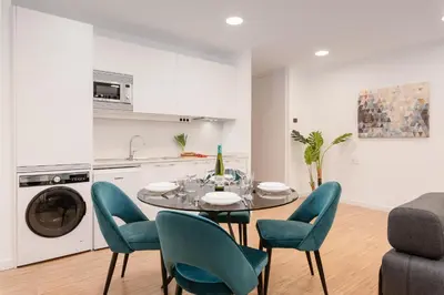 a kitchen and dining room with a table and chairs at I Loft Santiago by Upper Luxury Housing in Santiago de Compostela