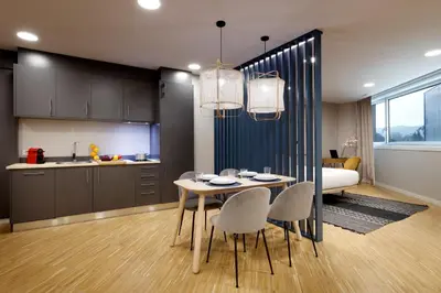 a kitchen and dining room with a table and chairs at I Loft Santiago by Upper Luxury Housing in Santiago de Compostela