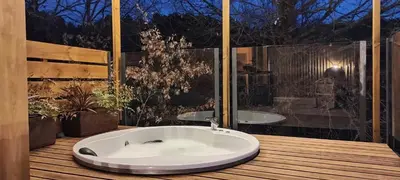 a bath tub sitting on top of a wooden deck at Cabanas Mirador Cachamuíña in Ourense