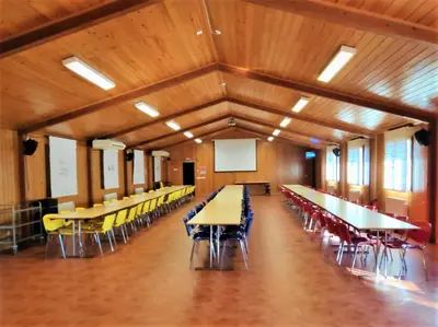 a large room with tables and chairs in it at Cabañas bungalow, El Bosque de los Sueños in Cubillos del Sil