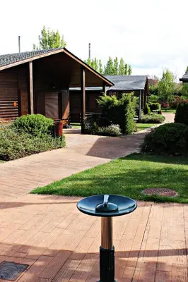 a black frisbee on a pole in front of a house at Cabañas bungalow, El Bosque de los Sueños in Cubillos del Sil