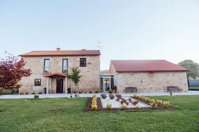 a stone house with a garden in front of it at Villa Rosa in Silleda