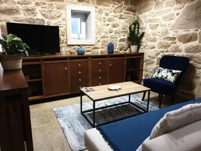 a living room with a tv and a table at Villa Rosa in Silleda