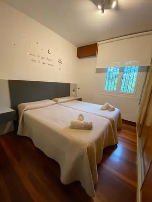 a bedroom with two beds with towels on them at CERCA DE TODO in Santiago de Compostela