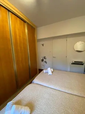 a small bedroom with a bed and a closet at CERCA DE TODO in Santiago de Compostela
