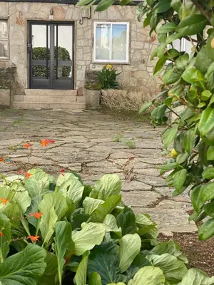 a stone walkway in front of a house with a door at CERCA DE TODO in Santiago de Compostela
