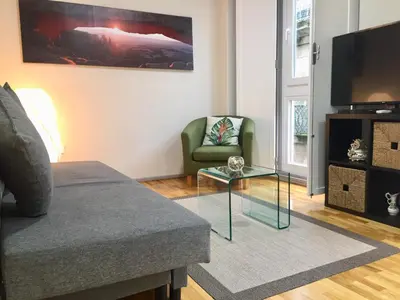 a living room with a couch and a glass coffee table at Catedral Centro Histórico in Ourense
