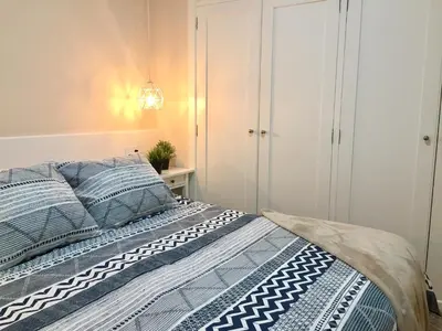 a bedroom with a bed with blue and white bedding at Catedral Centro Histórico in Ourense