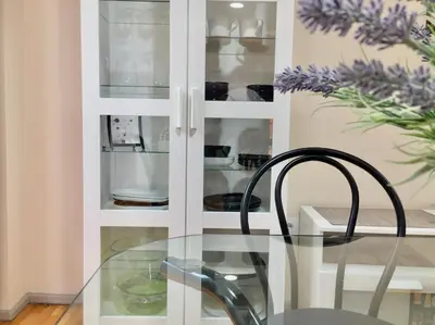a white cabinet with a glass table and a chair at Catedral Centro Histórico in Ourense