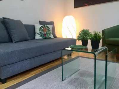 a living room with a couch and a glass table at Catedral Centro Histórico in Ourense