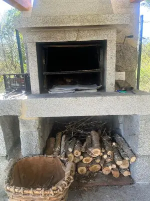 a stone oven with a bunch of logs in it at Espectacular Casa con Piscina en Allariz in Allariz
