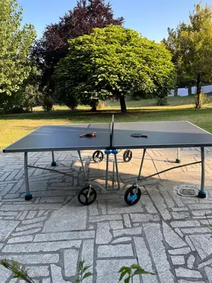 a ping pong table sitting on a stone patio at Espectacular Casa con Piscina en Allariz in Allariz