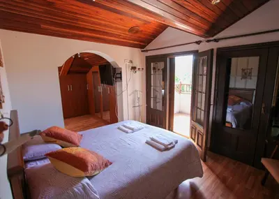 a bedroom with a large bed with white sheets and pillows at Espectacular Casa con Piscina en Allariz in Allariz
