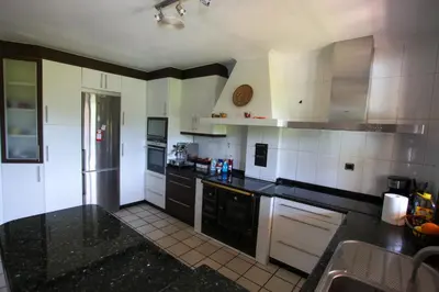 a kitchen with black counter tops and white appliances at Espectacular Casa con Piscina en Allariz in Allariz