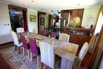 a dining room with a long table and purple chairs at Espectacular Casa con Piscina en Allariz in Allariz
