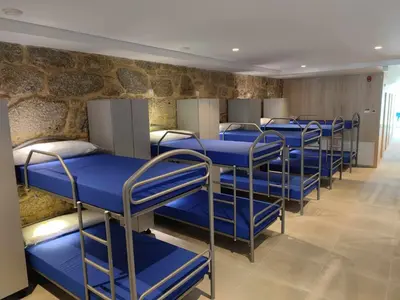 a row of bunk beds in a room at A Pousa do Asma in Chantada