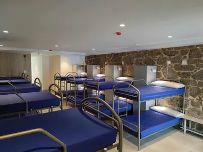 a row of blue bunk beds in a waiting room at A Pousa do Asma in Chantada
