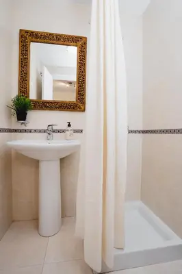 a bathroom with a sink and a mirror at Apartamentos LÓRIEN Milladoiro in Milladoiro