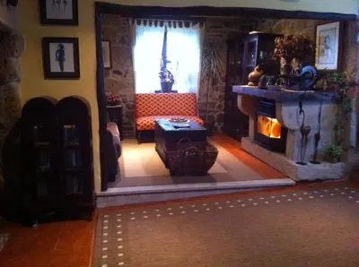 a living room with a couch and a fireplace at Casa das Augas Santas in Aguas Santas