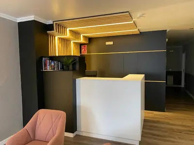 a lobby with a reception desk and a chair at Villa Alta in Villalba