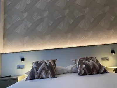 a bedroom with a large bed with a wooden headboard at Villa Alta in Villalba