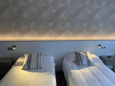 two beds sitting next to each other in a room at Villa Alta in Villalba
