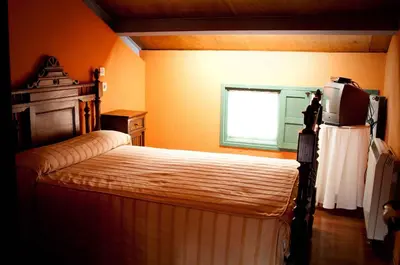 a bedroom with a bed with a television on it at Casa Don Din in Cruces