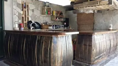 a bar made out of wooden wine barrels at Casa Don Din in Cruces