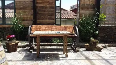 a wooden bench sitting in front of a building at Casa Don Din in Cruces