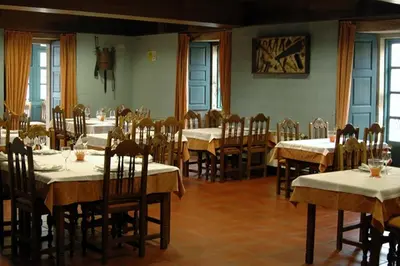 a dining room with tables and chairs with white tablecloths at Casa Don Din in Cruces