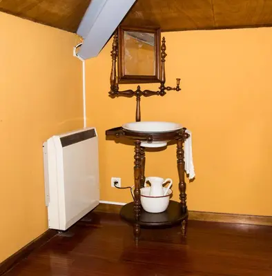 a bathroom with a sink and a small refrigerator at Casa Don Din in Cruces