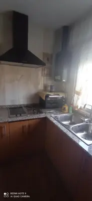 a kitchen with two sinks and a stove top oven at Casa Campanita in Ribadeo