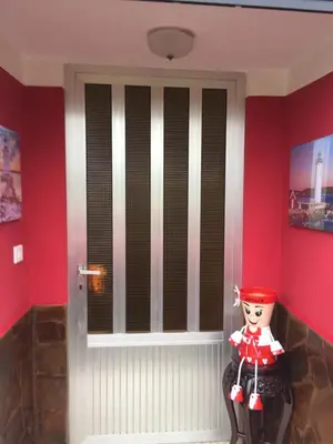 a door in a room with red walls at Casa Campanita in Ribadeo