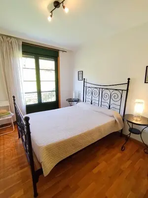 a bedroom with a large bed and a window at Indiano 2K in Viveiro