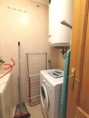 a laundry room with a washing machine in it at Indiano 2K in Viveiro