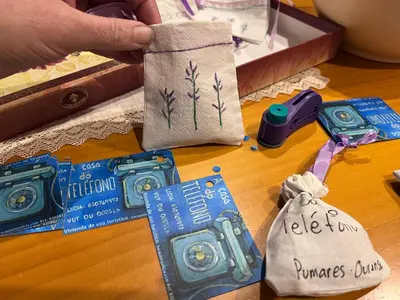 a table with a bag of items on a table at A casa do teléfono in Pumares