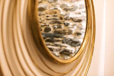 a close up of a mirror with a gold frame at casa boral in Doade
