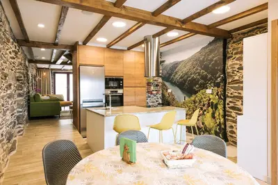 a kitchen and dining room with a table and chairs at casa boral in Doade