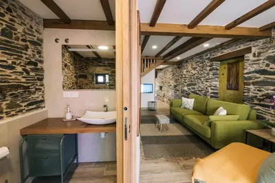 a living room with a green couch and a table at casa boral in Doade