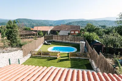 a backyard with a swimming pool and a fence at casa boral in Doade